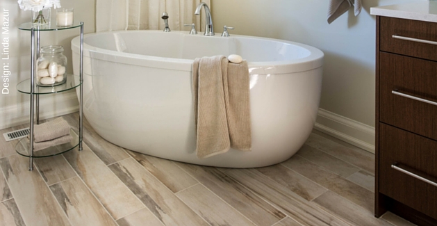 traditional bathroom with wood-look laminate and a large soaking tub